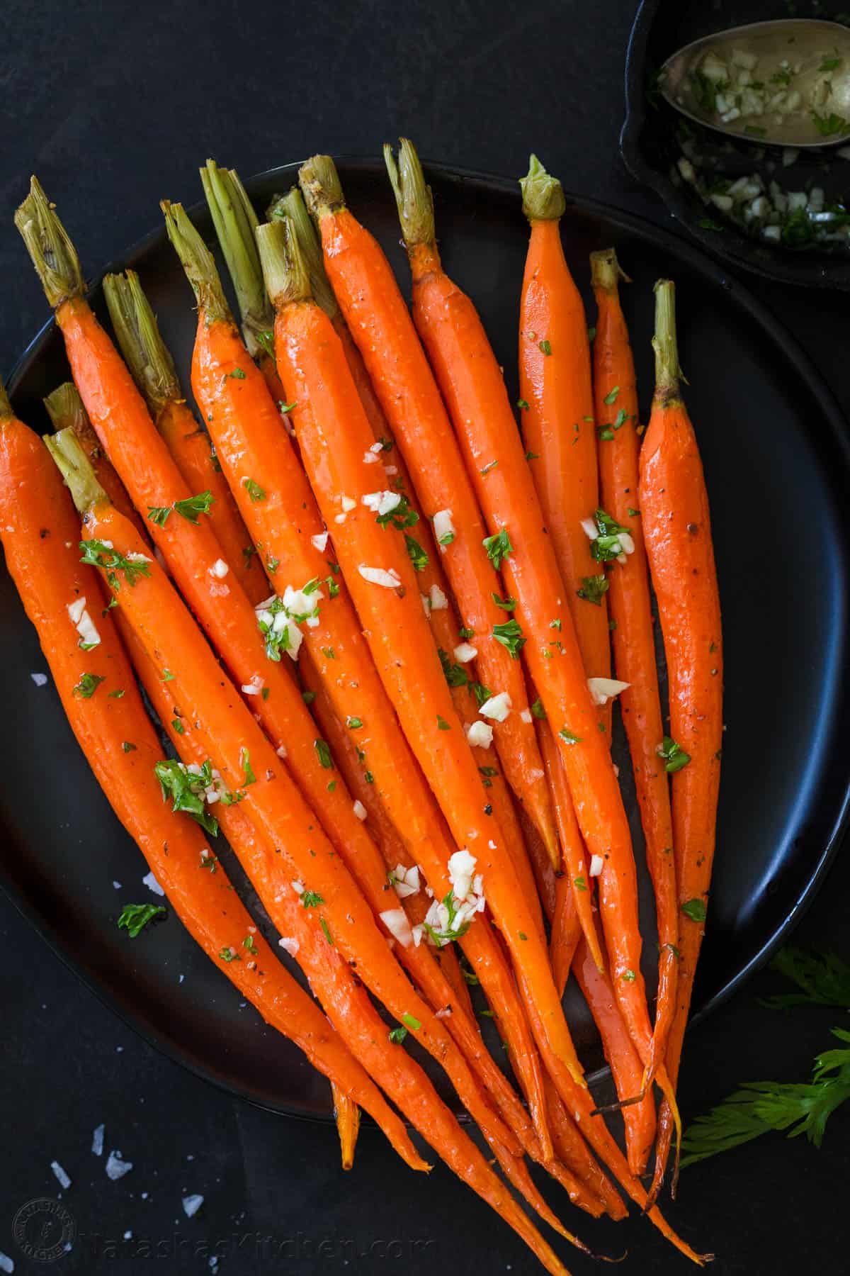 Roasted Carrots on a plate served with garlic oil. 