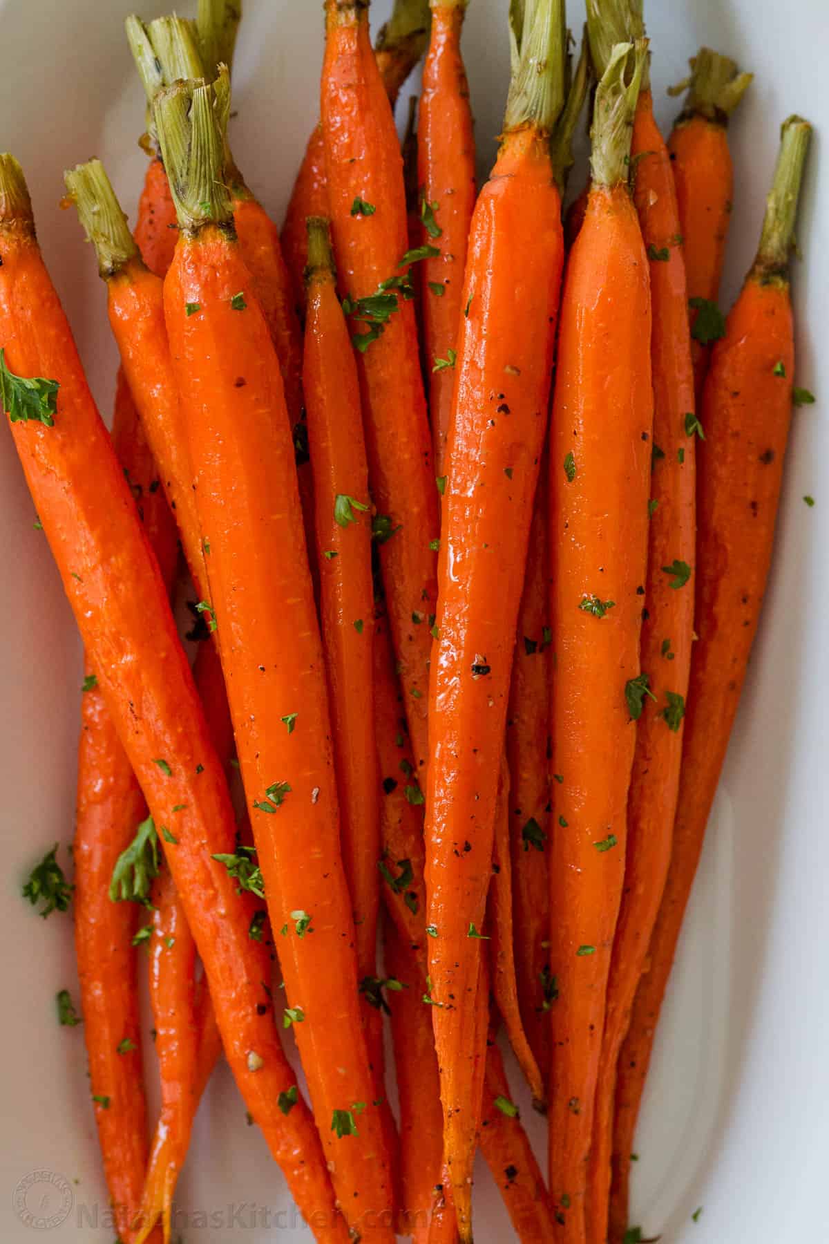 peeled roasted carrots on a baking pan 