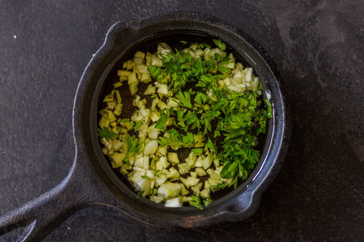 Garlic infused oil with parsley for drizzling over carrots