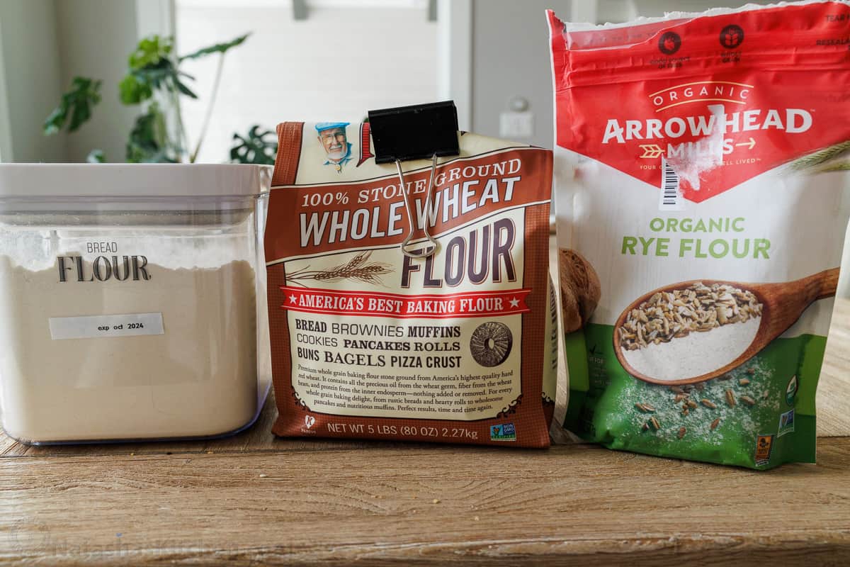 Flour, whole wheat flour and rye flour bags on a counter