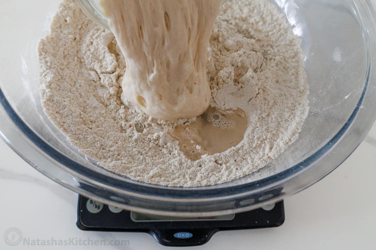 Adding sourdough starter using a digital kitchen scale to measure