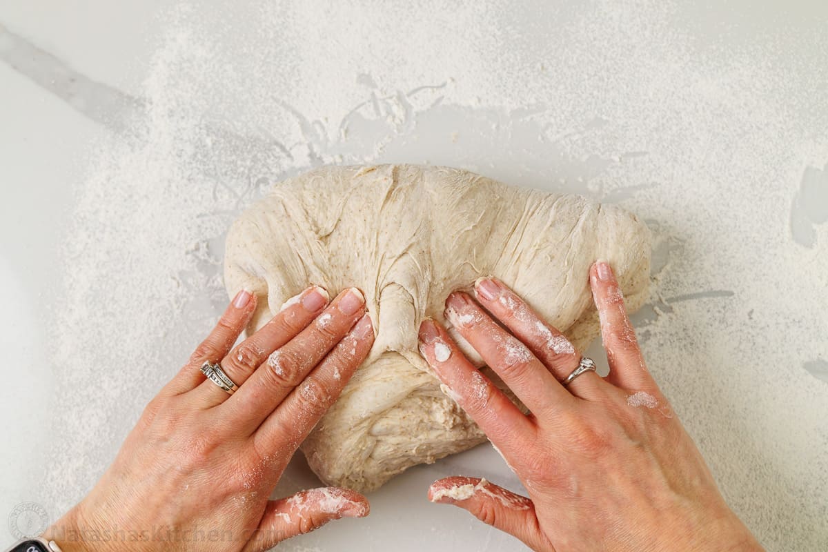 Kneading and shaping sourdough bread dough using hands