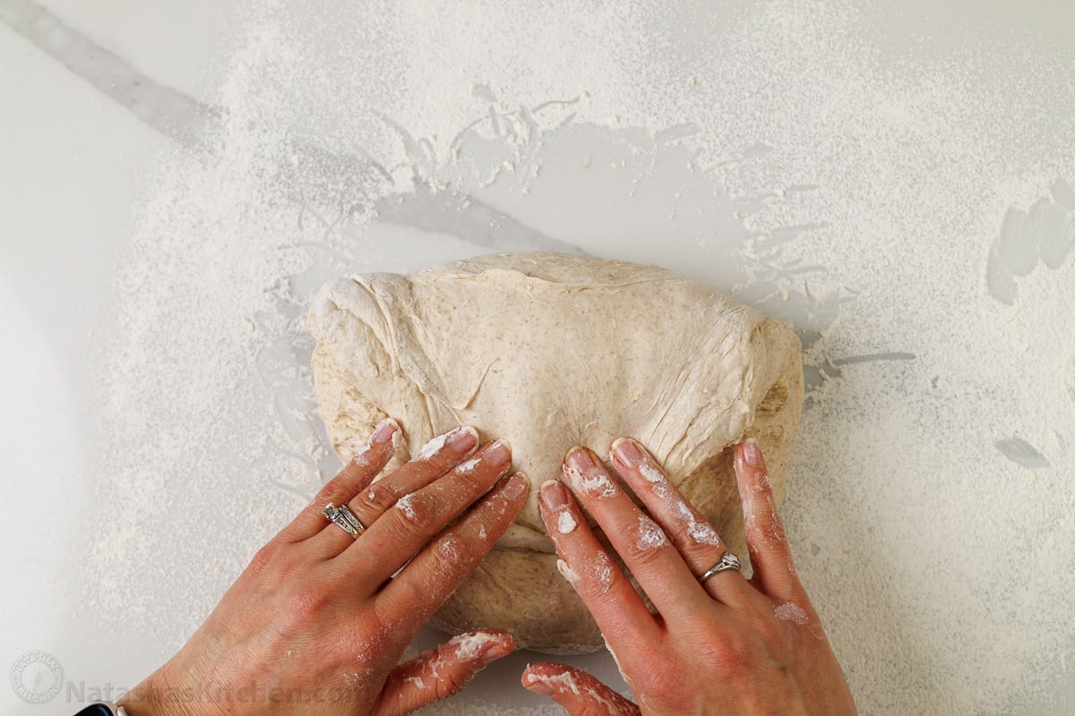 Folding the dough while shaping for the sourdough bread recipe