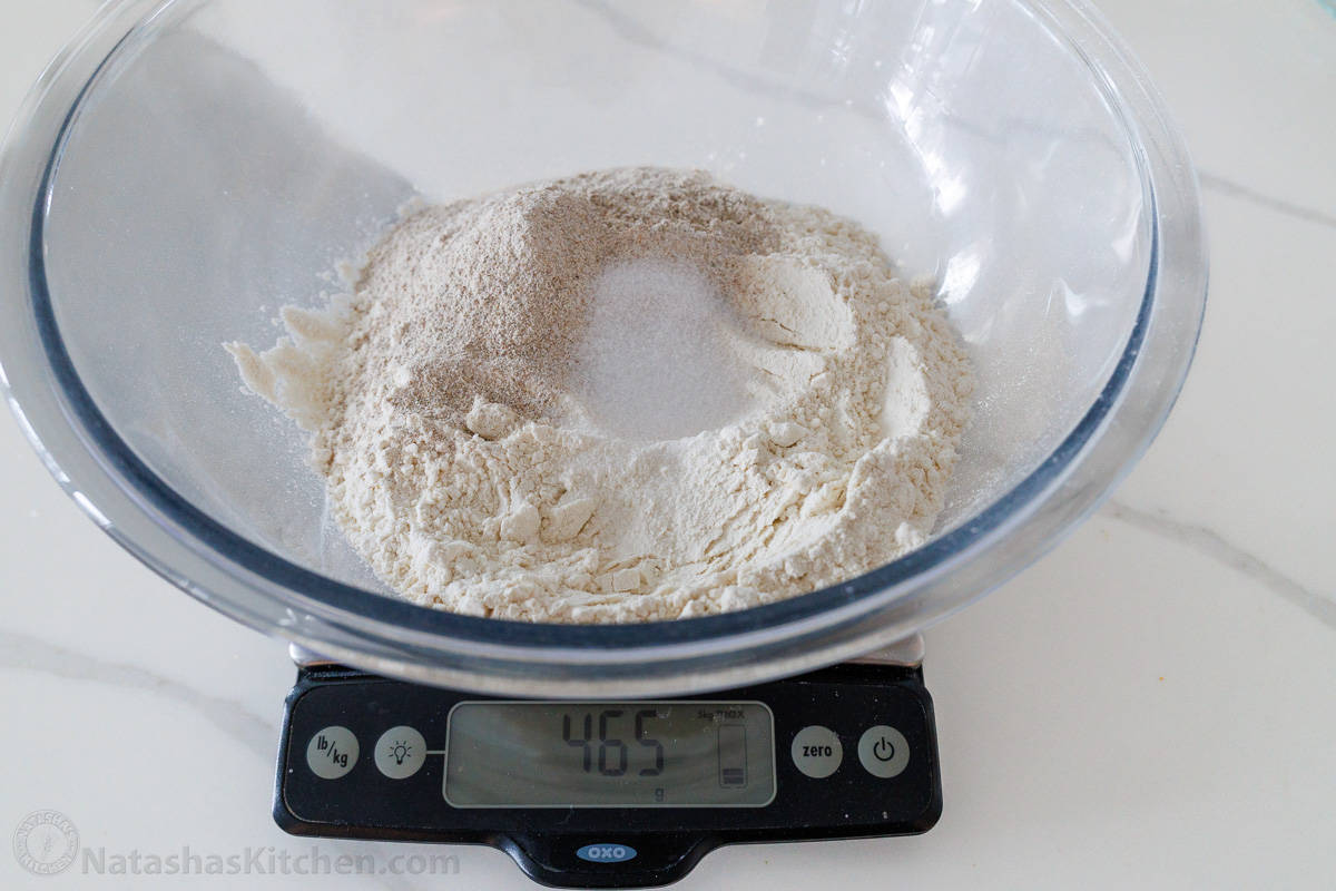 flour and salt in a mixing bowl on a kitchen scale