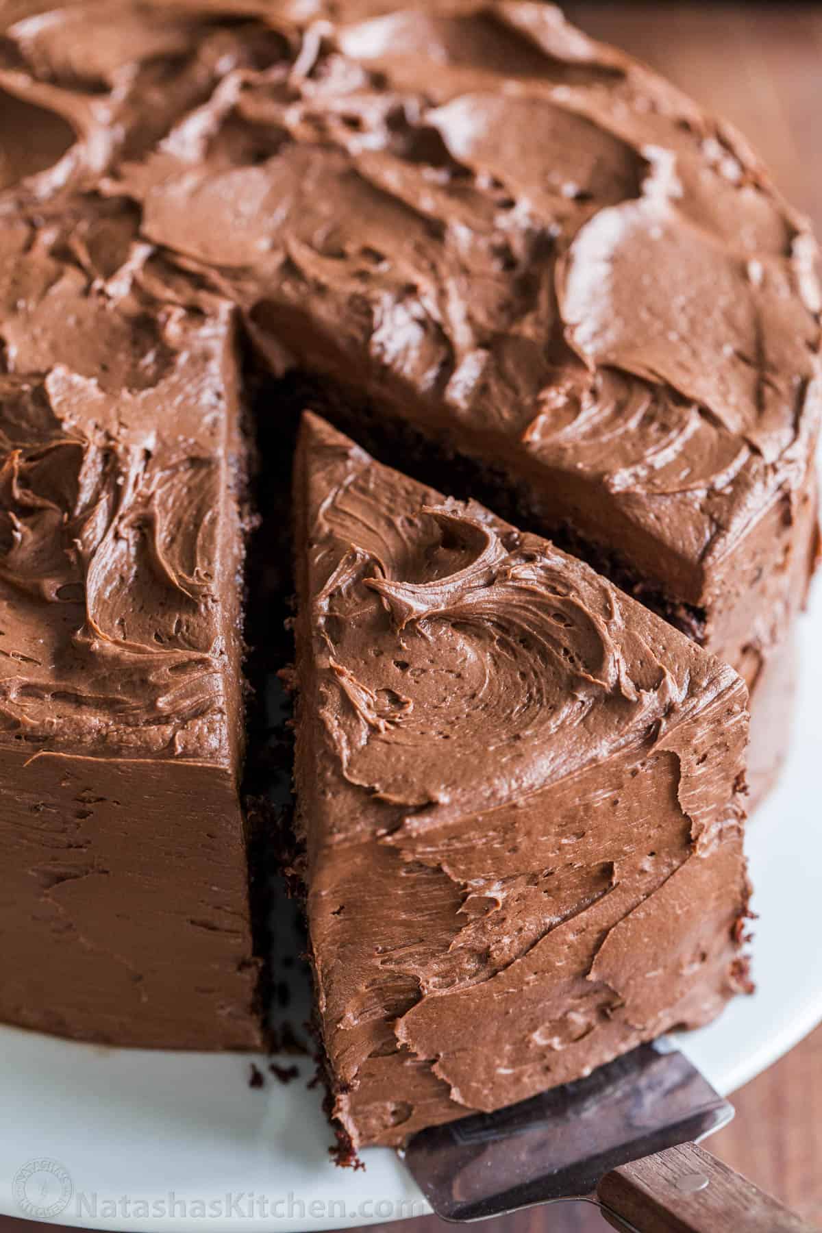 Chocolate cake with chocolate frosting with slice being removed