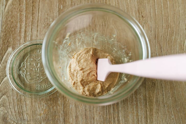 Mixing together flour and water to make starter