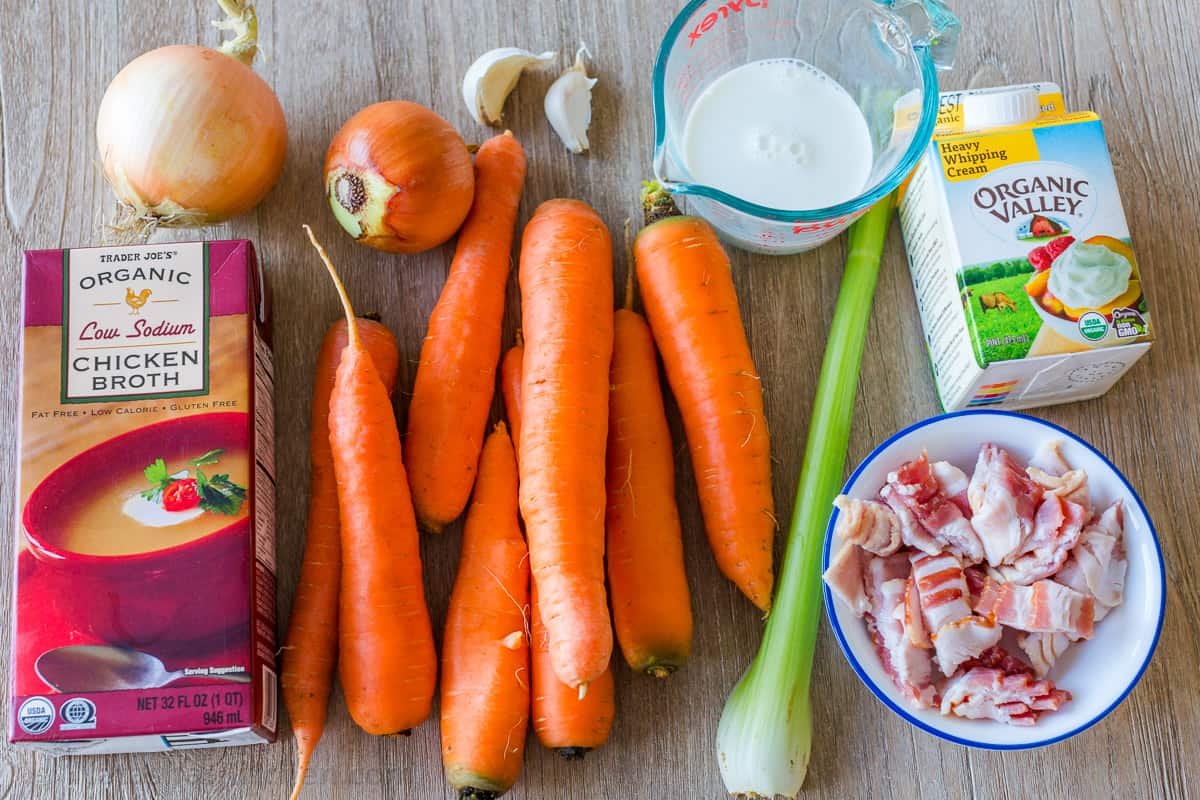 Carrot soup recipe ingredients with carrots, celery, onion, garlic, bacon, broth, cream and milk