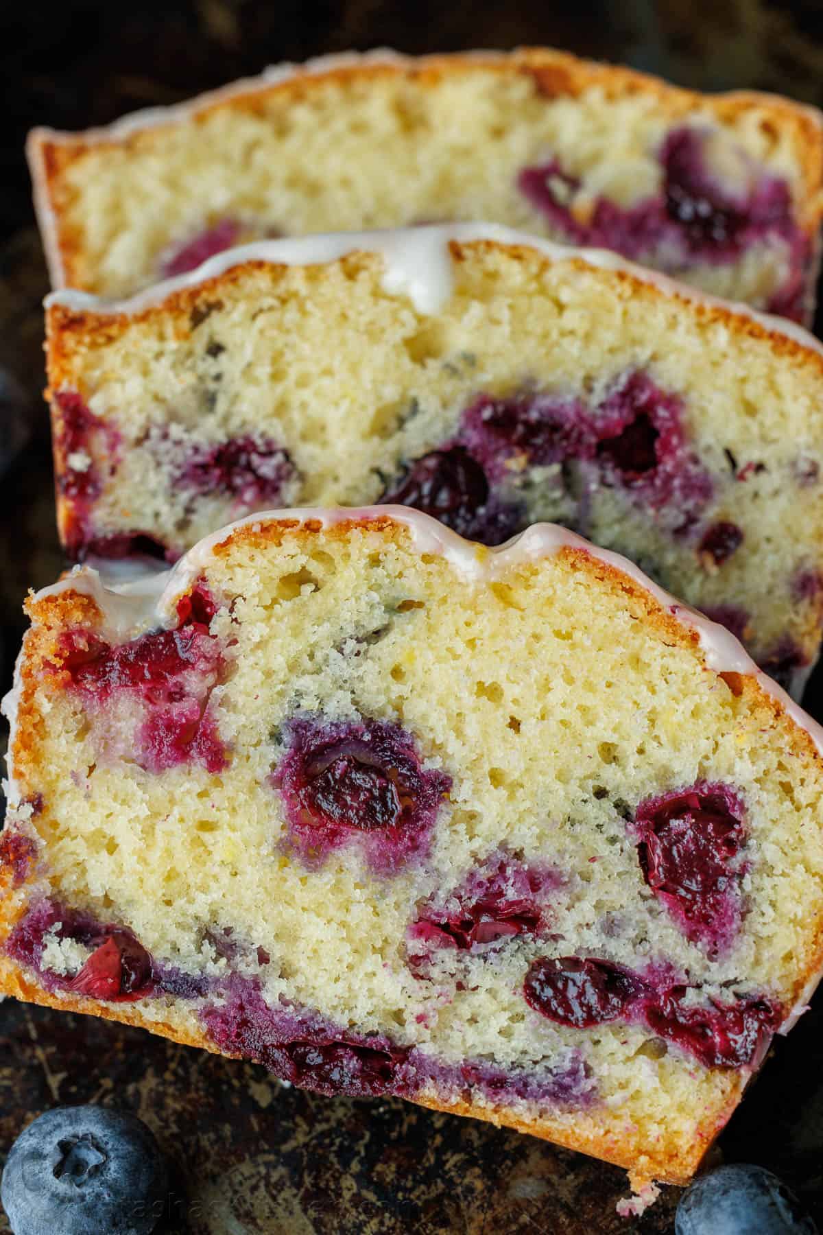 Blueberry Lemon Bread sliced to showcase juicy blueberries baked in the batter