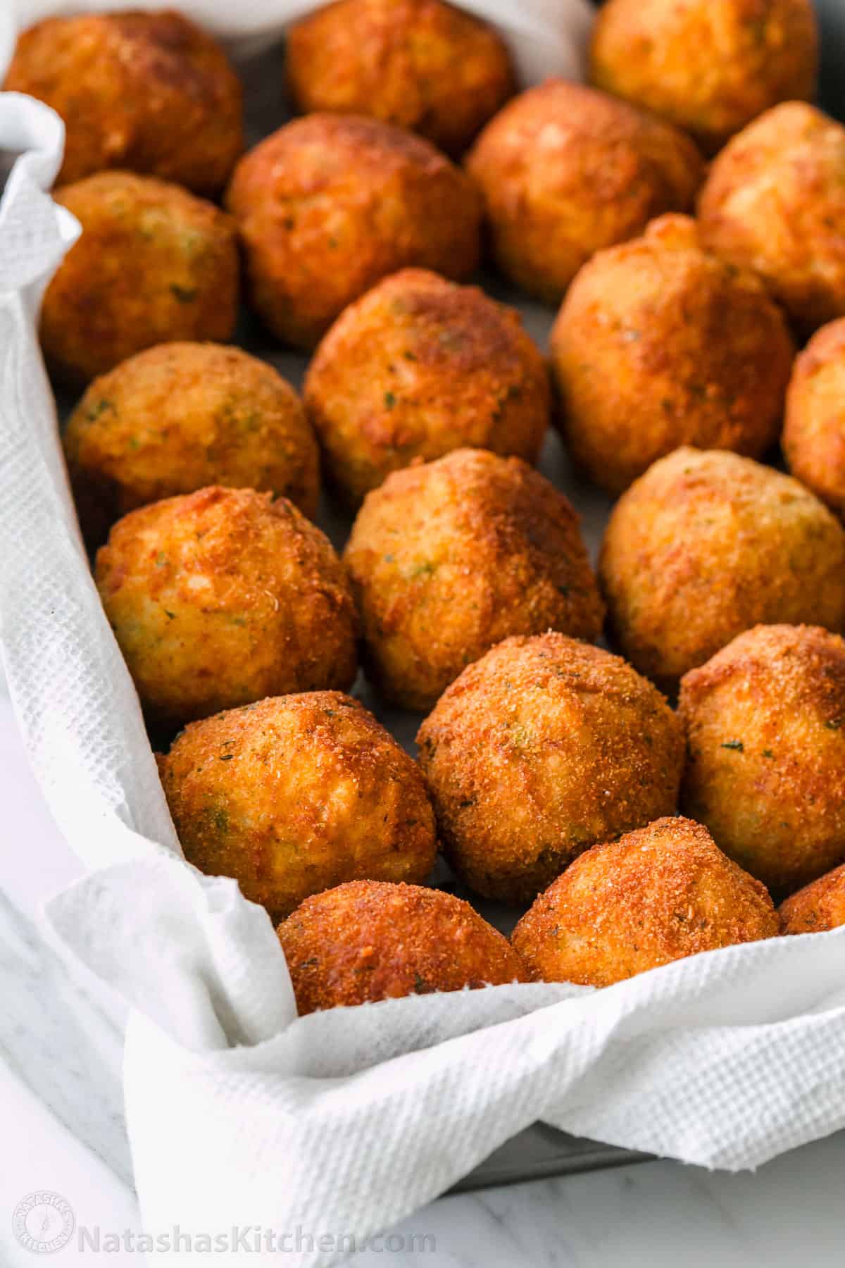 Fried Arancini rice balls resting on paper towels