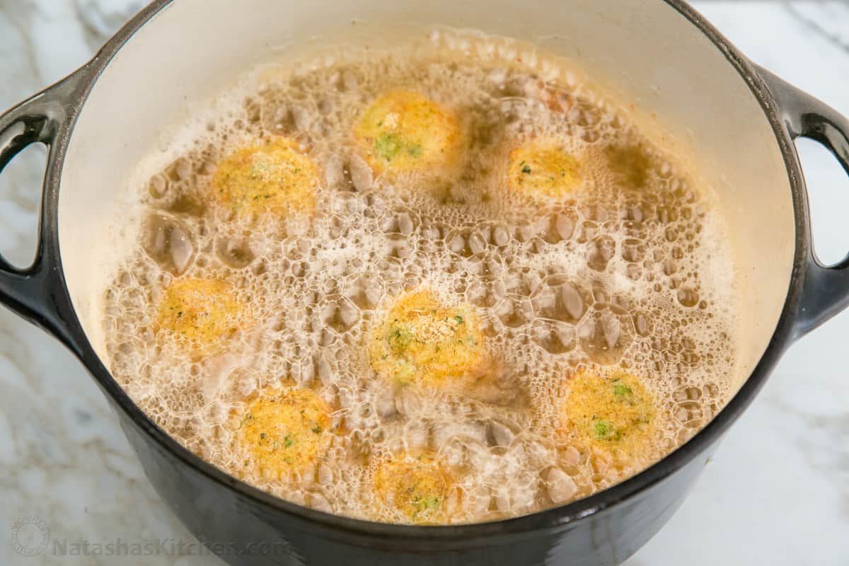 Arancini frying in a pot of oil