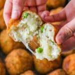 Arancini rice ball open to the cheesy center