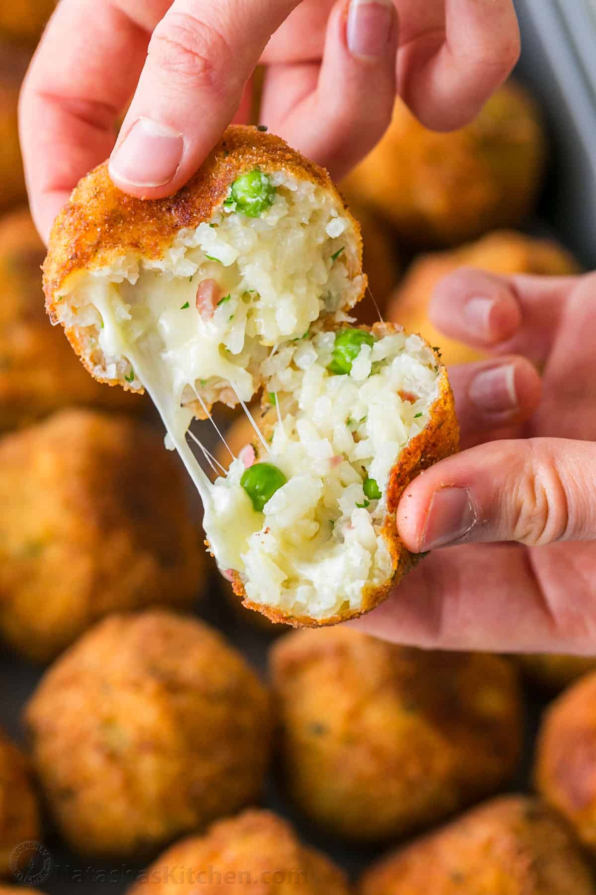 Center view of arancini rice ball with melted gooey cheese