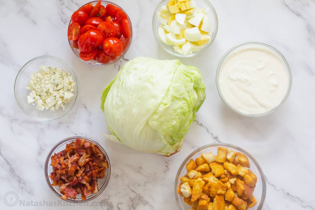 Ingredients for wedge salad in ramekins on a platter. 