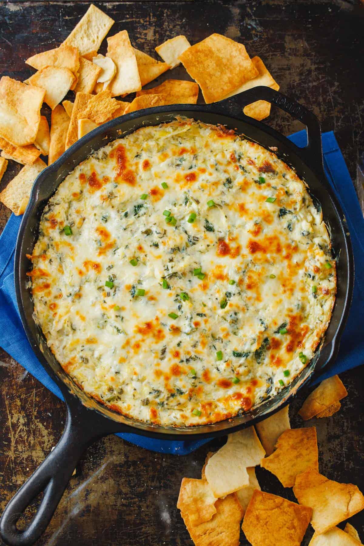 Baked Spinach and Artichoke Dip in a baking pan, ready to serve