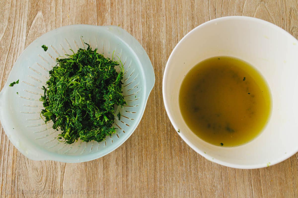 Frozen spinach in a colander, squeezed dry