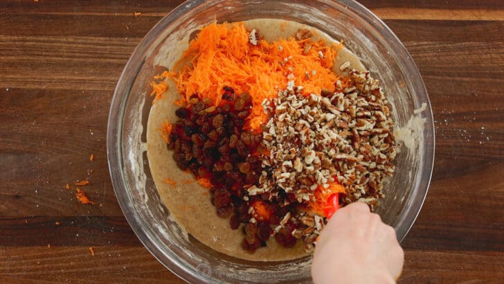 Adding shredded carrots and add-ins