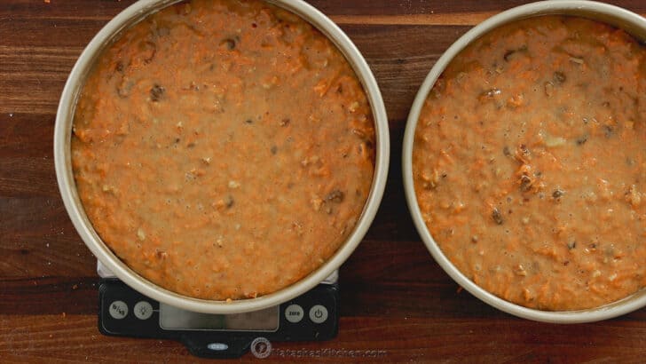 Dividing cake batter between pans on a kitchen scale