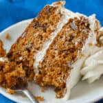 Slice of moist carrot cake on a plate with fork