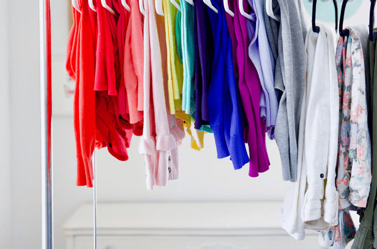 clothes hanging on a portable clothing rack