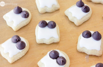 Adorable ghost cookies with white frosting and black olives.