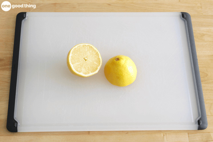 a lemon that has been cut in half sitting on top of a cutting board