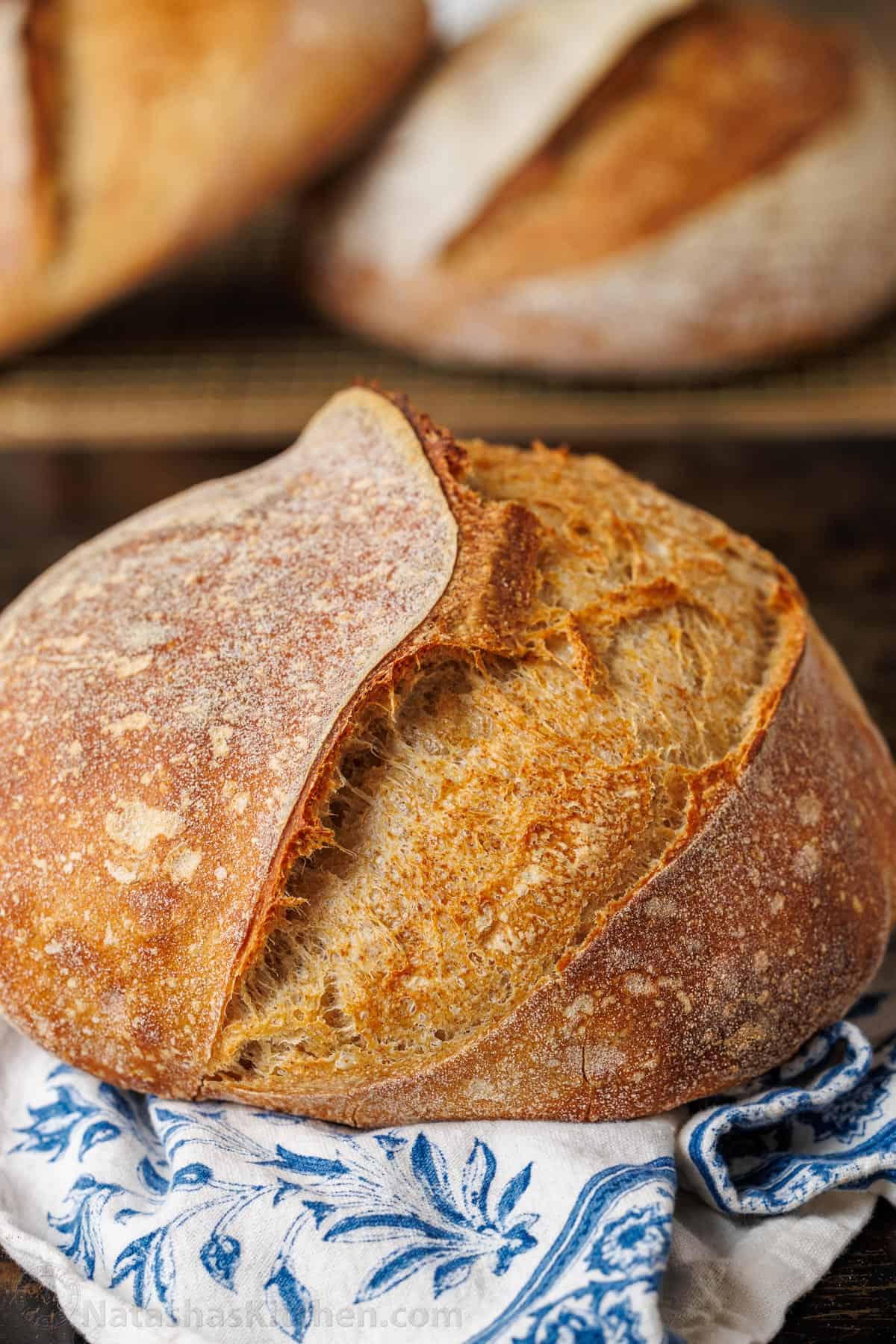 Sourdough bread boule with blue and white tea towel